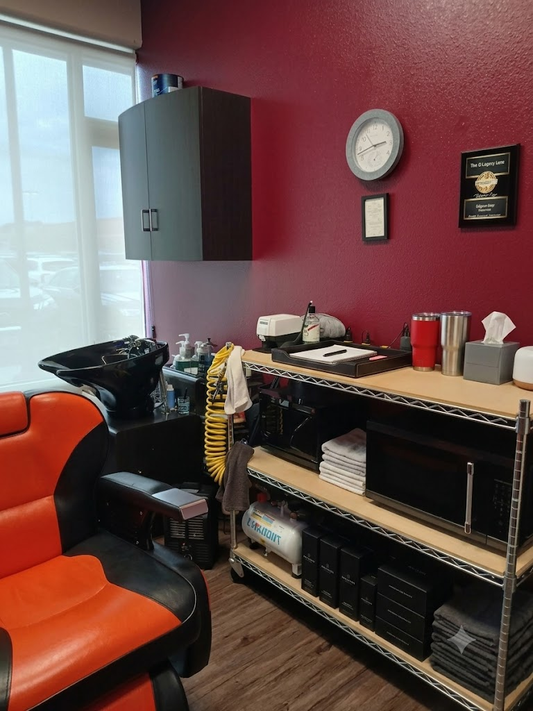 Clean wash station with a black shampoo basin, reclining chair, folded towels, and neatly arranged grooming products